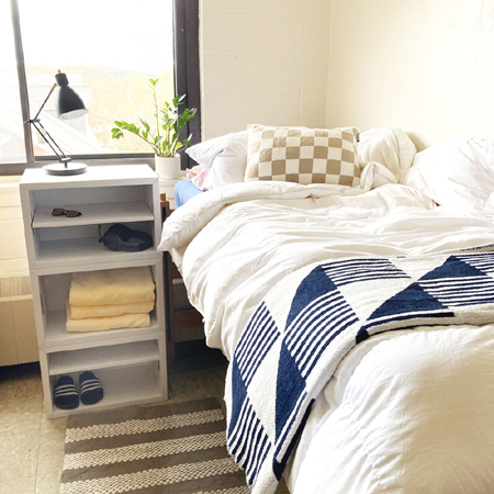 Muvo Box stacked as a tall nightstand beside a raised dorm bed